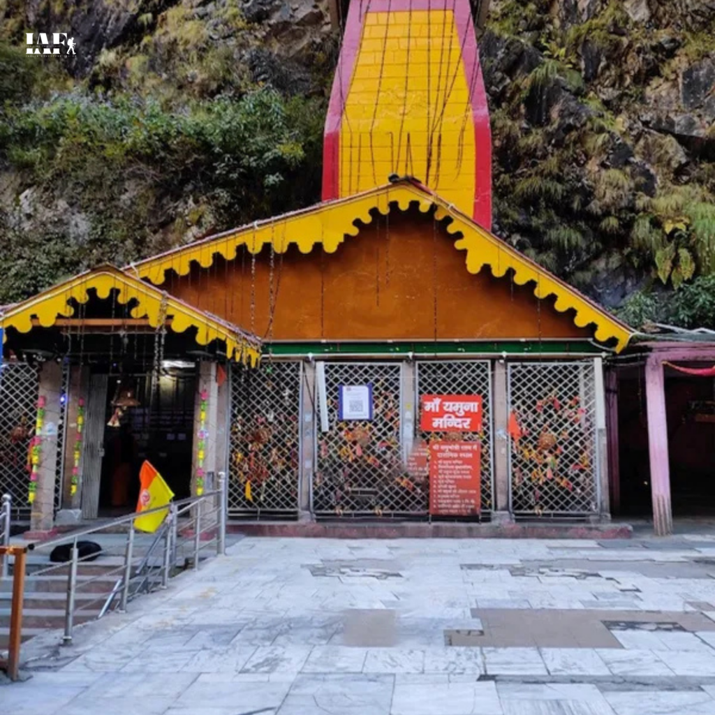 Yamunotri Temple complex with red-roofed structure and devotees gathered in the Himalayan hills of Uttarakhand.