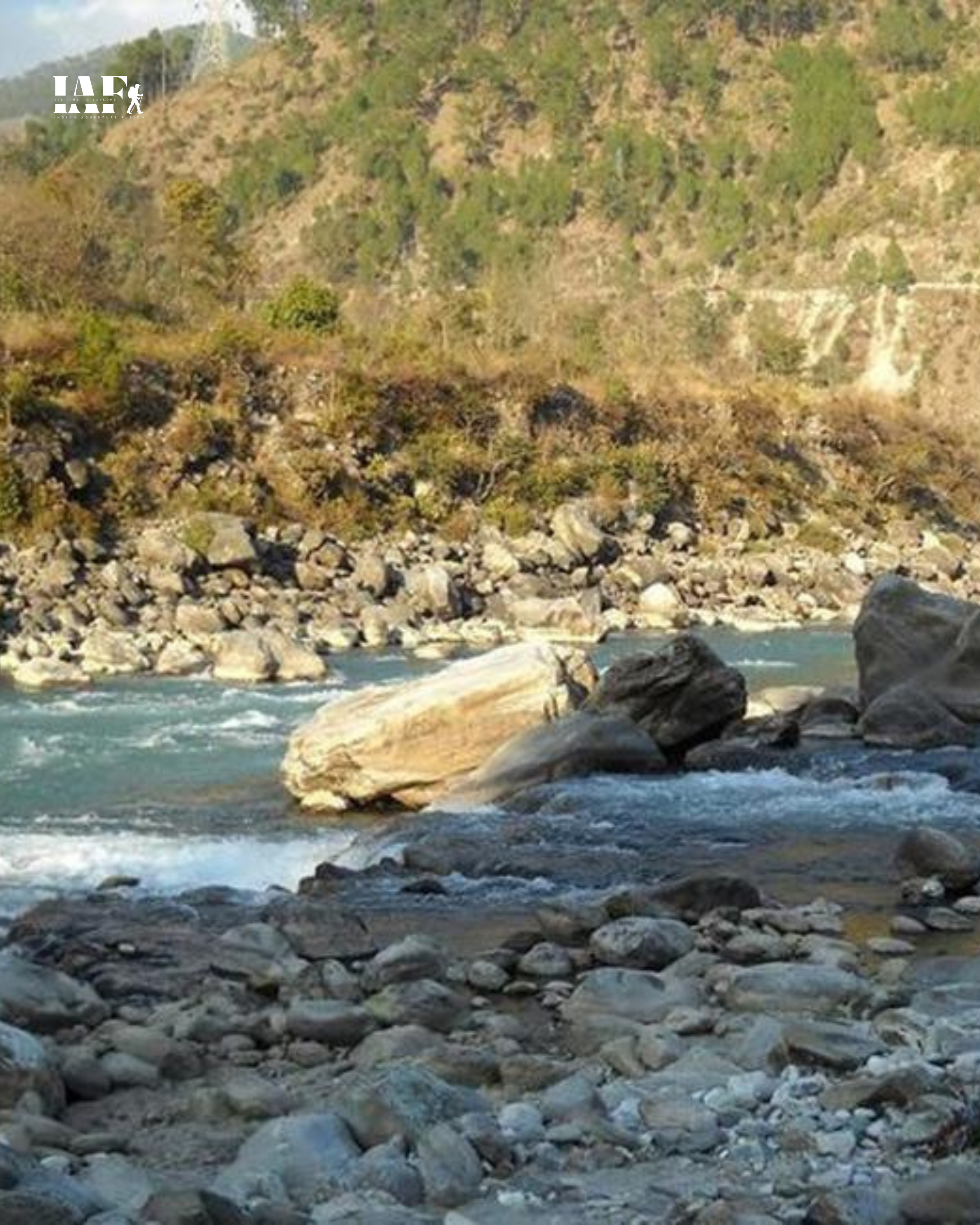 Rocky riverbank view of Alaknanda River at Nandprayag in the Garhwal Himalayas.